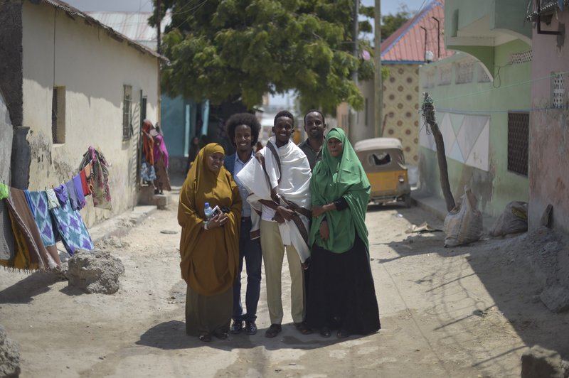 Mohamed Hussein Hassan (second from left), Chairman of City Flowers — an NGO which organizes events and aims to celebrate the beauty of their city — and his team on a road outside their offices in Mogadishu, Somalia. Their projects include city clean-ups,