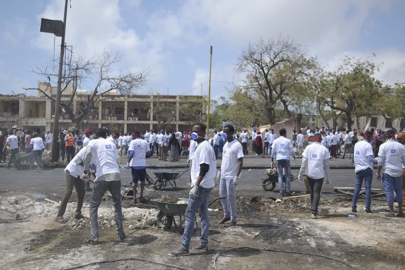 Students from various universities in Mogadishu, Somalia, who came together under the umbrella group ‘Gurman Qaran’ help in the cleanup effort at the scene of the explosion that killed more than 300 people in the capital on 14 October 2017.
