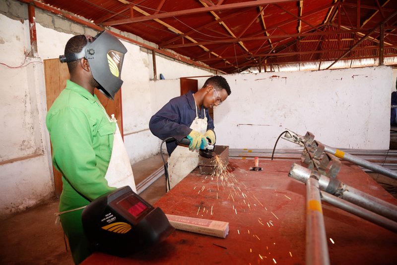 A trainee grinds metal during a vocational training in Kismaayo Technical Institute, Somalia. The trainee is one of the beneficiaries of the ‘Dal Dhis’ project, launched by UNIDO, which provides vocational training to youths in Kismaayo.