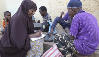 Jamila Haji Mohamed, Chair-lady of the Mis-Hurty Arlaathey organization, takes the contact information of children leaving on the streets of Baidoa, Somalia. Jamila has helped enroll street children in formal schools.