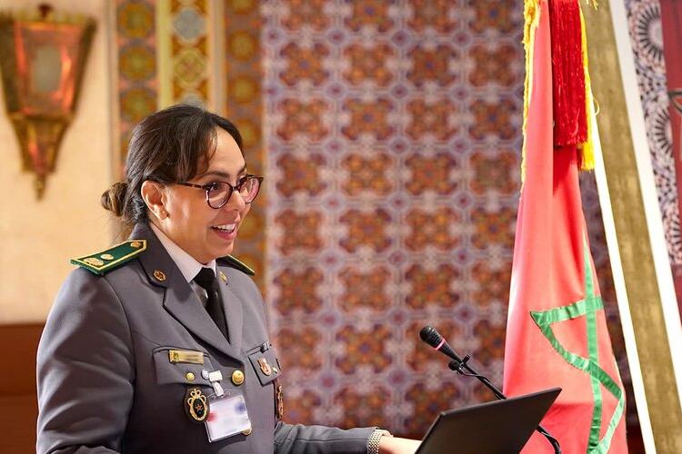 A woman in uniform stands at a podium
