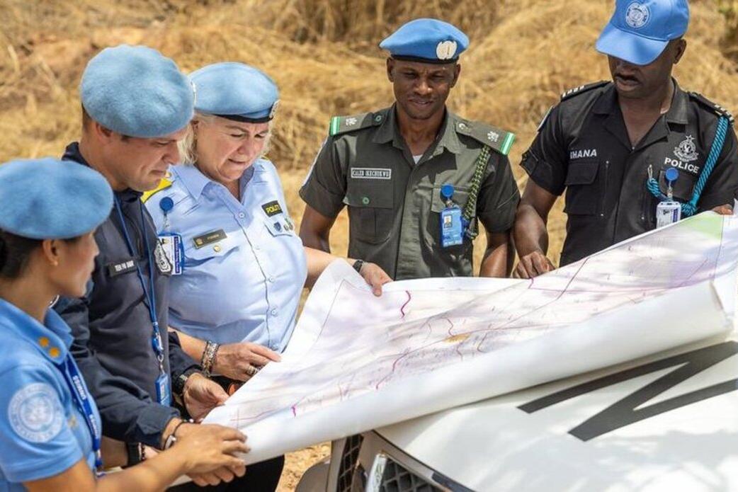Police officers deployed to the UN peacekeeping mission in South Sudan consult a map