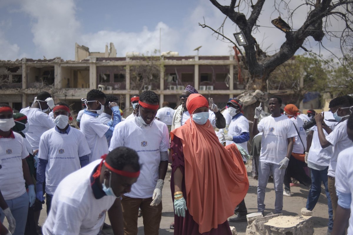 Students from various universities in Mogadishu, Somalia, who came together under the umbrella group ‘Gurman Qaran’ help in the cleanup effort at the scene of the explosion that killed more than 300 people in the capital on 14 October 2017.