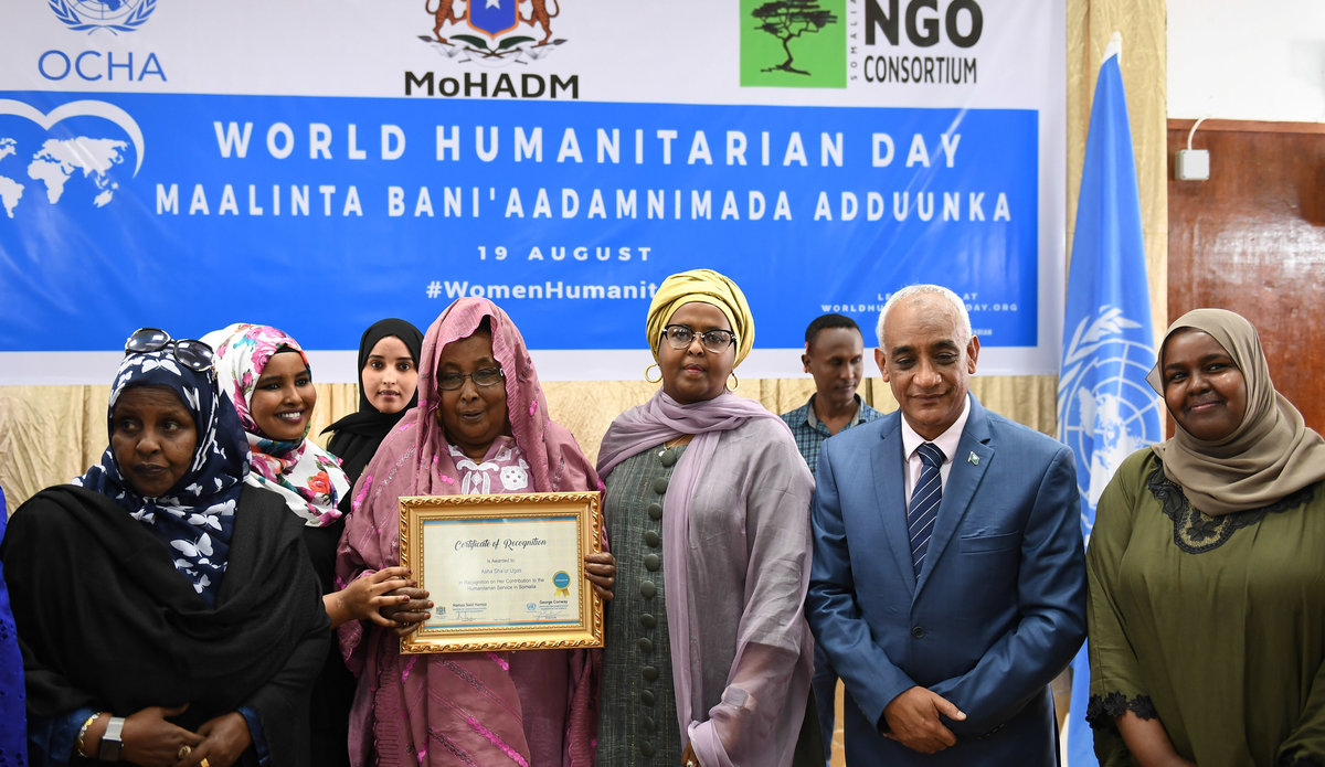 Asha Shaur Ugas holds a certificate awarded to her in recognition of her contribution to the promotion of humanitarian work. This was during an event to mark the World Humanitarian Day on 19 August 2019 in Mogadishu, Somalia. UN Photo / Omar Abdisalan