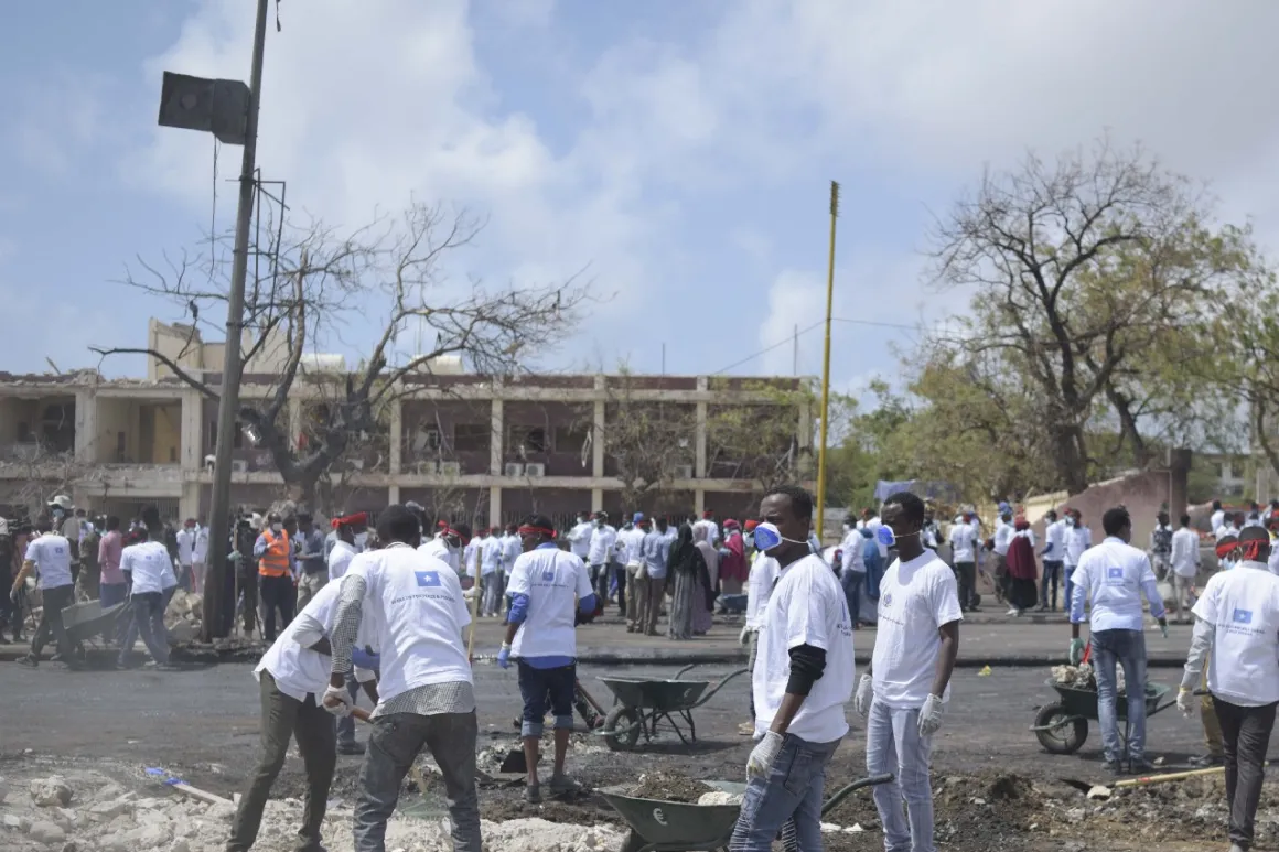 Students from various universities in Mogadishu, Somalia, who came together under the umbrella group ‘Gurman Qaran’ help in the cleanup effort at the scene of the explosion that killed more than 300 people in the capital on 14 October 2017.